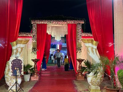 Wedding entrance with decorative conch pillars and red carpet at Dharam Vatika, Sohna Gurgaon