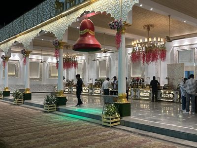 Arcade entrance with red bell decor and floral chandeliers, Dharam Vatika Sohna Gurgaon
