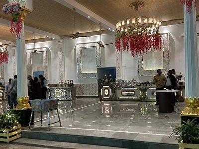 Dining hall with lotus-base pillars and chandeliers at Dharam Vatika, Sohna Gurgaon