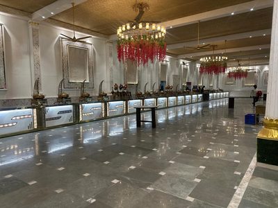 Long illuminated buffet counter line in the hall at Dharam Vatika, Sohna Gurgaon
