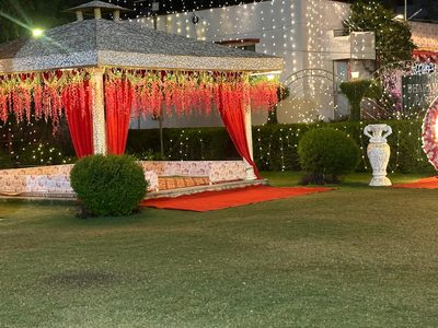 Floral gazebo on the fairy-lit lawn at Dharam Vatika party lawn, Sohna Gurgaon