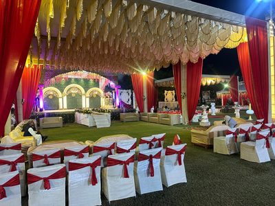 Guest chairs and sofas with stage and lawn pavilions at Dharam Vatika wedding venue, Sohna Gurgaon